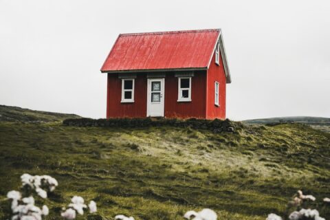 red and white house surround green grass field