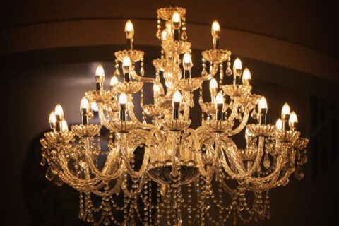 brass uplight chandelier turned on in room