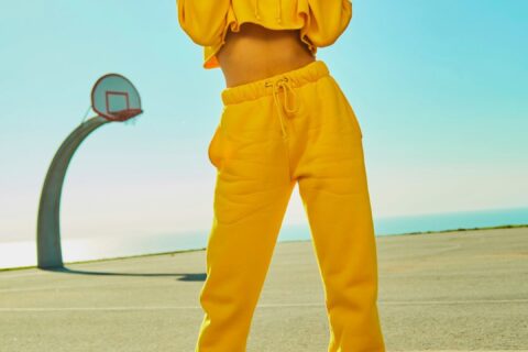 woman in yellow tracksuit standing on basketball court side