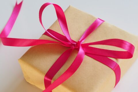 brown gift box with pink ribbon
