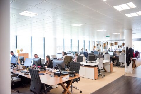 people working at desks in open office