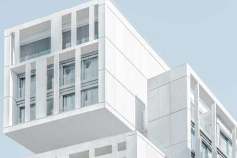 white modern cement building under blue sky